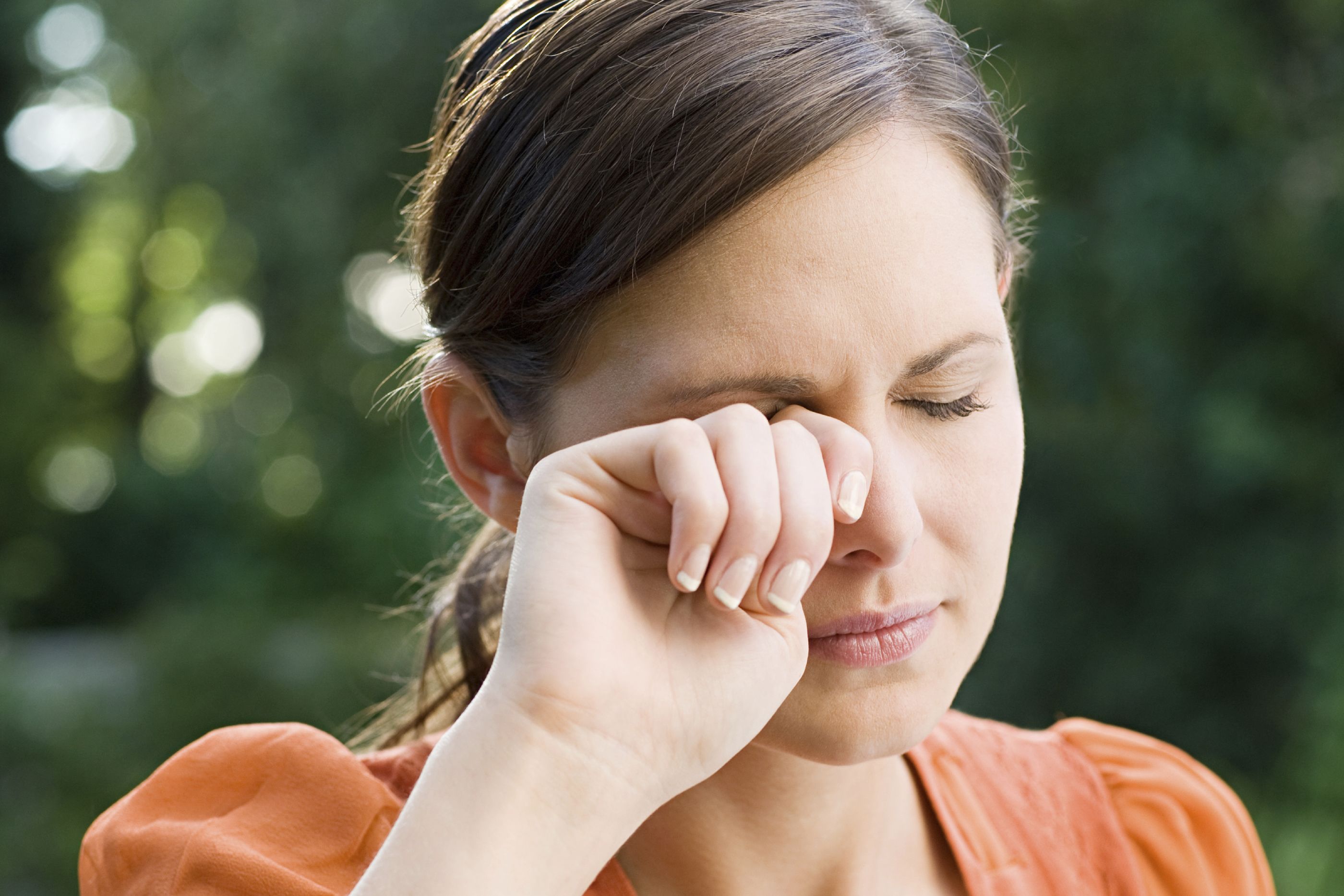 A woman rubbing her eyes